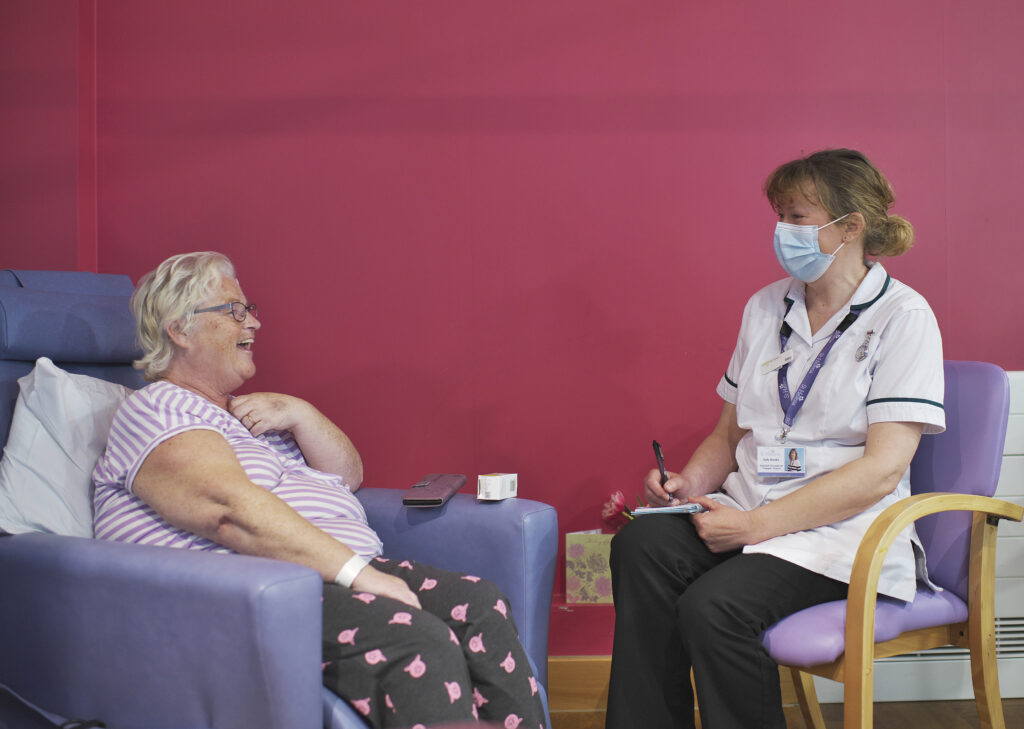 Terminal patient talking to a hospice nurse