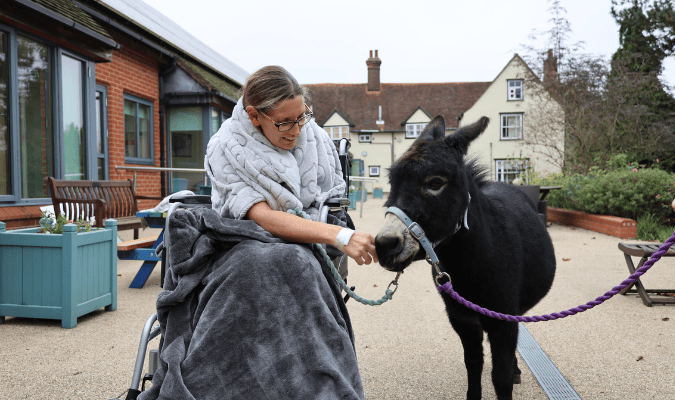 Julie at hospice with donkey