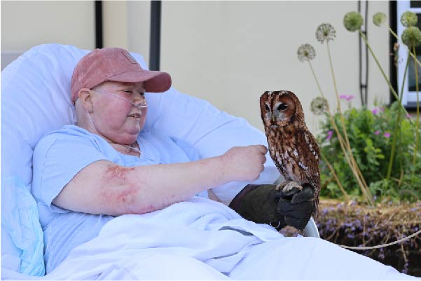 Terri at St Helena Hospice holding a barn owl