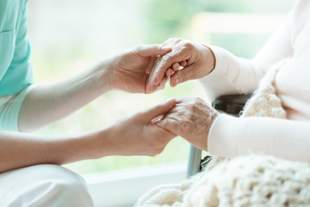 Hospice care holding hands for support