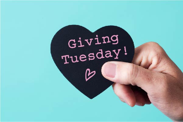 Hand holding Giving Tuesday heart sign
