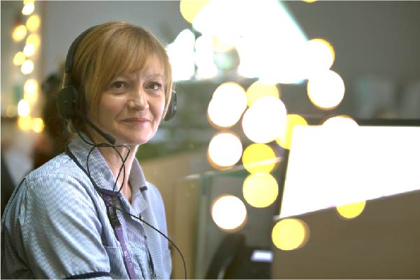 Hospice nurse on the phone with twinkly fairy lights