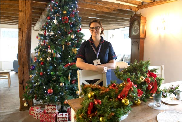 Hospice matron with Christmas tree and presents